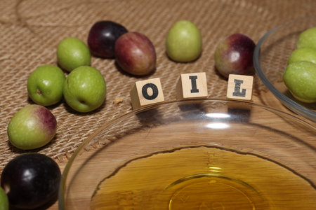 Olives and Olive Oil on wooden backgroundの写真素材