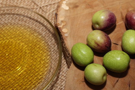 Olives and Olive Oil on wooden backgroundの写真素材