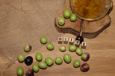 Olives and Olive Oil on wooden backgroundの写真素材