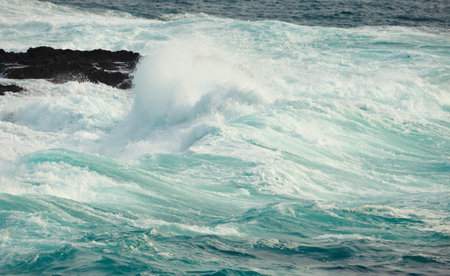 Powerful ocean waves crashing on rocky shoreline, UK.の写真素材
