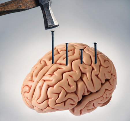 Human brain with nails hammered into it, symbolizing extreme mental pain, psychological trauma, anxiety, stress, or manipulation.の写真素材