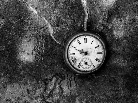 This is an old clock placed at the ground.