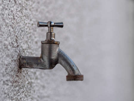Outside tap on white wallの写真素材