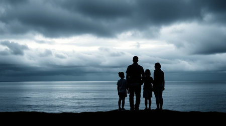 Silhouetted family gazing at the vast ocean beneath a moody, dramatic sky. Evokes feelings of hope, togetherness, and the beauty of nature. Ideal for travel blogs, family-focused campaigns, and evoking a sense of peace.の素材