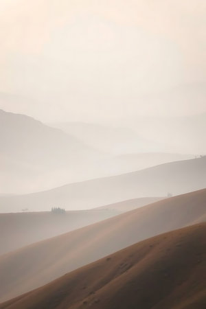 Gentle rolling hills fade into a dreamy, atmospheric landscape. Perfect for conveying a sense of calm, peace, and natural beauty. Ideal for travel blogs, wellness brands, and serene marketing campaigns.の素材