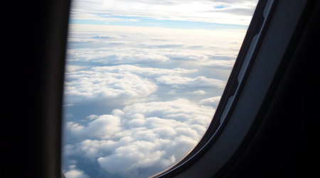 Experience the vastness of the sky from an airplane window, gazing at an endless expanse of fluffy clouds. Perfect for travel, adventure, and freedom themes.の素材