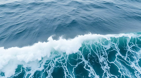 Experience the raw power and breathtaking beauty of the ocean with this stunning aerial view of a crashing wave, showcasing vibrant turquoise hues and intricate white foam patterns.の素材