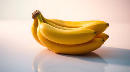 Experience the vibrant allure of fresh yellow bananas, artfully arranged with soft studio lighting and a captivating reflection for ultimate visual appeal.の素材
