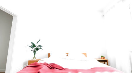 A bright, modern bedroom evokes a sense of calm and relaxation. With its luxurious pink blanket and peaceful plant, it's the perfect place to start your morning.の素材