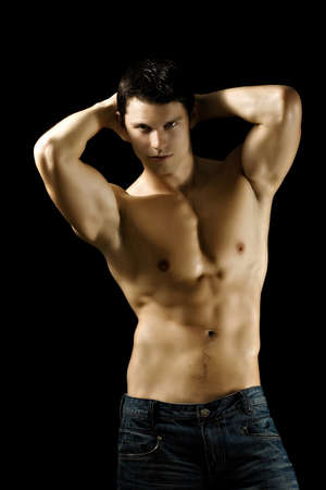 Sexy muscular man isolated on black backgroundの写真素材