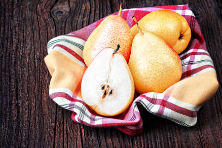 Fresh pears on old brown wooden table(selective focus).の写真素材