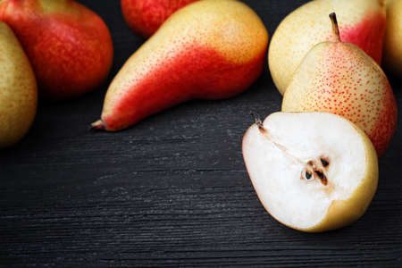 Fresh pears on old black wooden table(selective focus).の写真素材