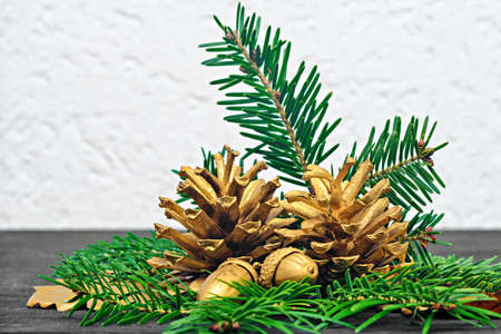 Still life concept with golden pine cones and acorns (selective focus).Use it for different holiday greeting cards -  Advent, Christmas or New Yearの写真素材