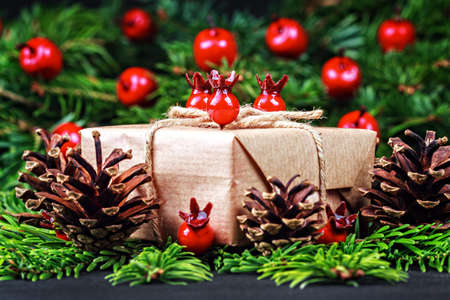 Christmas gift box and decorations on black wooden table (selective focus).の写真素材