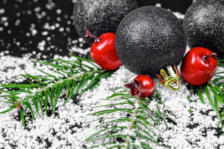 Christmas ornaments with pine tree branches on a black backgroundの写真素材