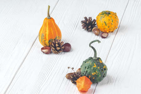 Seasonal natural decorations on white wooden table in minimalist style (selective focus)の写真素材