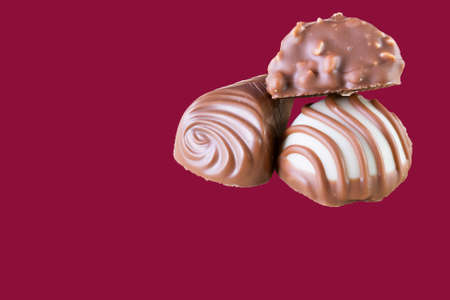 Chocolate pralines on  wood dark red background. Macro imageの写真素材