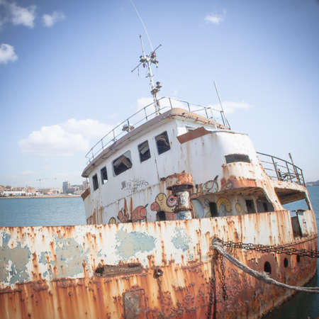 Shipwreck at the pier. harbor of Cagliari - Sardinia.の写真素材