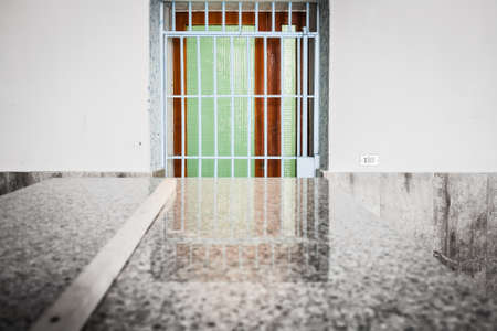 Barred and colorful  door with reflection on granite table