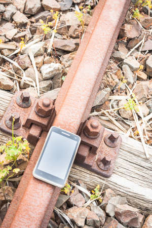 Travel on the tracks of the technology. Smartphone on rail like a metaphor.の写真素材