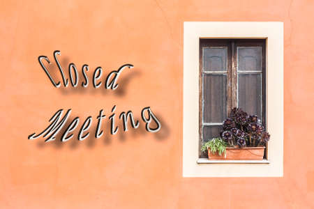 Closed window with planter  and orange wall, with written Closed Meeting