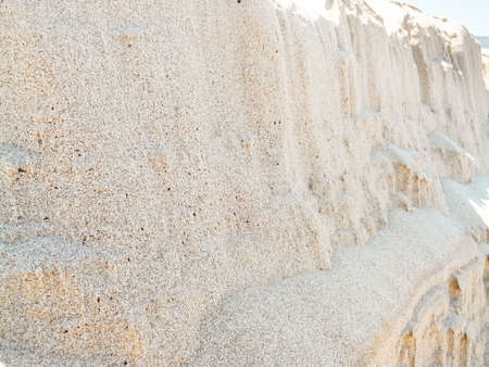 cliffs sand grains. In front of a mountain of sandの写真素材
