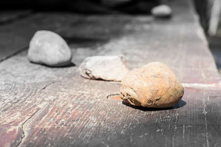 Stones lined wood. Close up of stones on a wood tableの写真素材