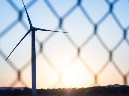 Wind Turbines in the country a sunset. Silhouette version with wire meshの写真素材