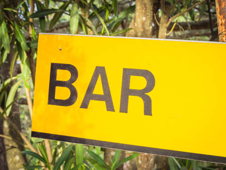 Yellow signboard bar. Sign that indicate bar and place where it's possible drink and eat.の写真素材