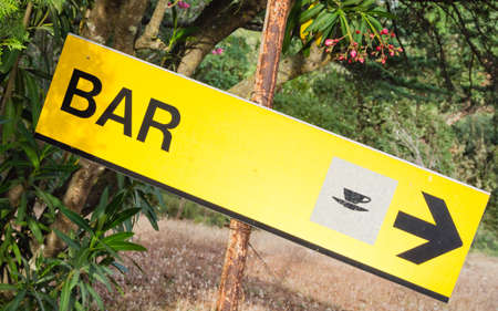 Yellow signboard bar. Sign that indicate bar and place where it's possible drink and eat. Symbol of cup of coffeeの写真素材