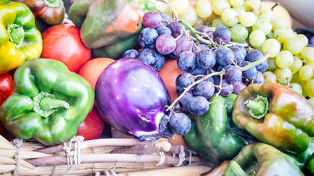 eggplant peppers grapes. Fruits and vegetables in season exposed in a street marketの写真素材