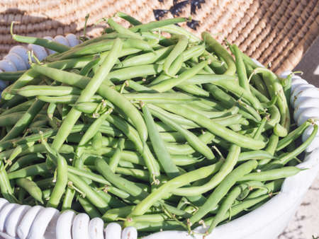 basket of green beans. Fruits and vegetables in season exposed in a street market