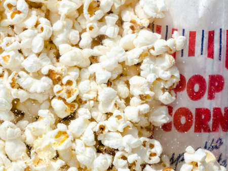 Hundreds popcorns background. Popcorns behind the glass of popcorn machineの写真素材