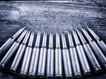 Many bullet on the wood. bullets of various calibersの写真素材