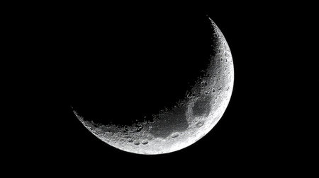 A stunning crescent moon floats against a dark night sky, showcasing intricate lunar surface details. Ideal for themes of astronomy, nature, and tranquility.の素材