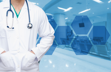 smart doctor with a stethoscope around his neck on the hospital blurred and hexagonal shaped pattern background, medical technology concept, copy space.の写真素材