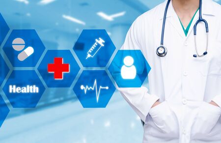 smart doctor with a stethoscope around his neck with health care icons and hexagonal shaped pattern on the hospital blurred background, health care and medical technology concept.の写真素材