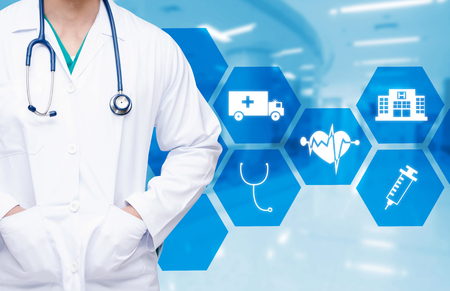 smart doctor with a stethoscope around his neck on the hospital blurred and hexagonal shaped pattern background, health care and medical technology concept, copy space.の写真素材