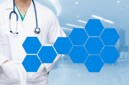 smart doctor with a stethoscope around his neck on the hospital blurred and hexagon shaped pattern design background, healthcare medical technology concept, copy space.の写真素材