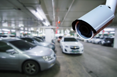 cctv security camera on blurred background of indoor car park, security technology concept.の写真素材