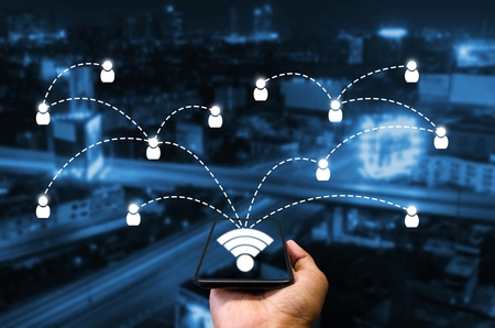 smart phone in hand and using internet wifi network connection communication technology concept on...