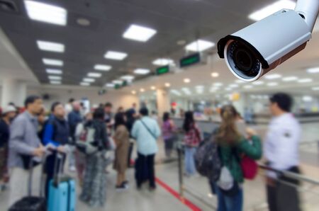 cctv security camera on blurred image of tourist queue at immigration control at airport, security technology concept.の写真素材