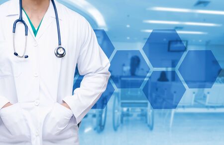 smart doctor with a stethoscope around his neck on the hospital blurred and hexagon shaped pattern design background, healthcare medical technology concept, copy space.の写真素材