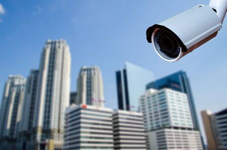 security CCTV camera with blurred office building background.