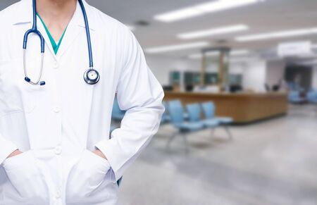 smart doctor with a stethoscope around his neck on the hospital blurred background,  health care medical technology concept.の写真素材