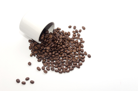 coffee beans and white coffee cup on white backgroundの写真素材