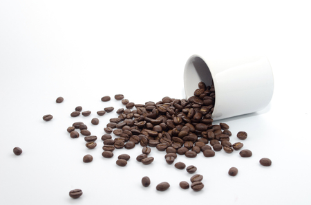 coffee beans and white coffee cup on white backgroundの写真素材
