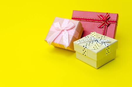 mini colorful gift box on yellow background, holiday sale and online shopping concept, selective focus, copy spaceの写真素材