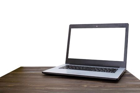 Laptop computer with white blank screen on wooden table with white background, selective focus, copy spaceの写真素材