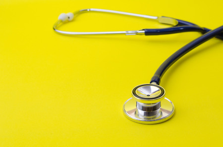 stethoscope on yellow background, heart health care and medical technology concept, selective focus, copy spaceの写真素材